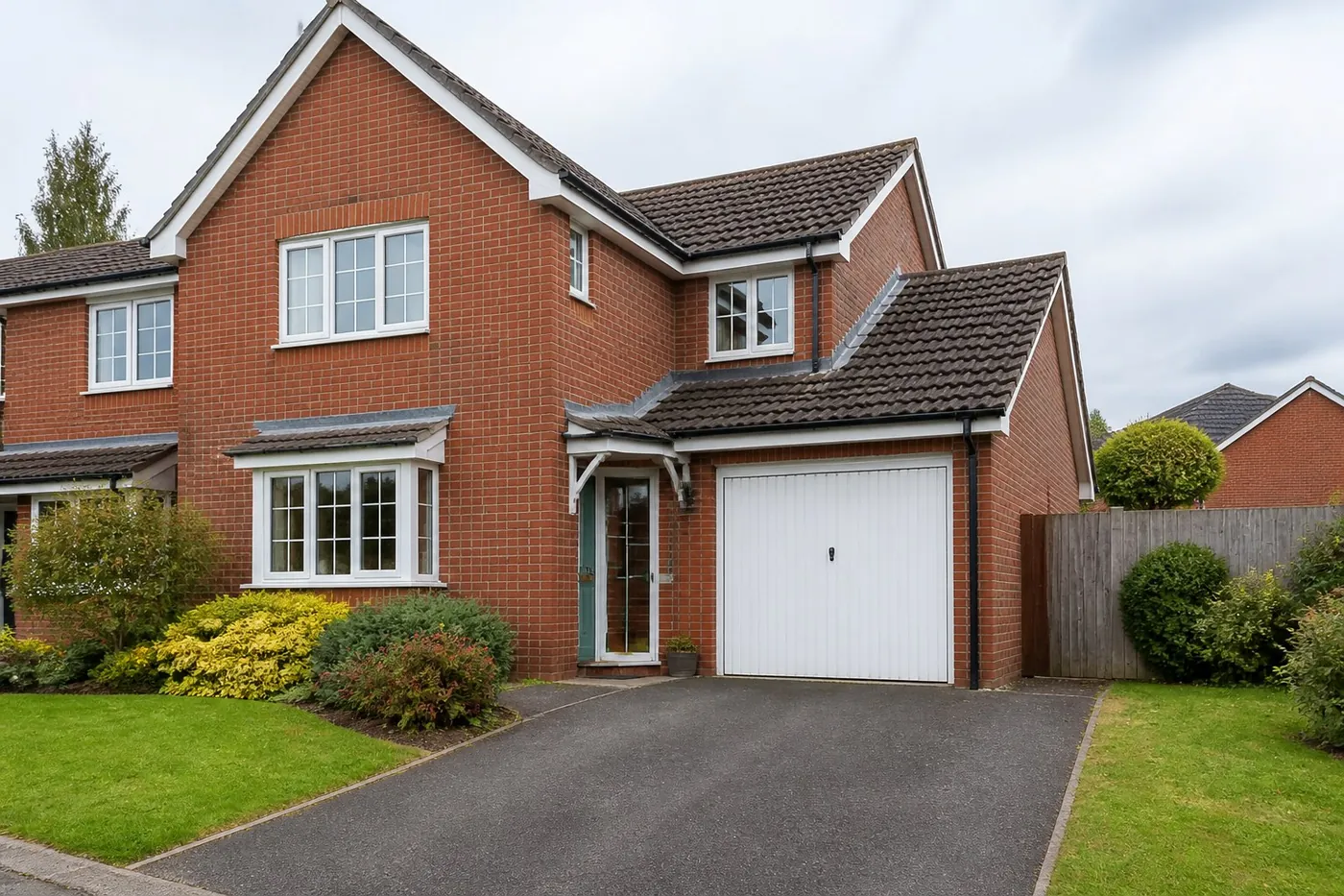 British brick house with an attached garage and driveway